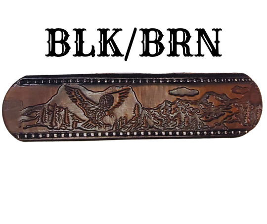 Get ready for an unforgettable climb to the top with The "Eagle Mountain" Name Belt! This one-of-a-kind belt features a 1 1/2" width and is hand-stained with a strip of vegetable tanned leather. The bold design includes a embossed Stitch border and Eagle center pattern, while the solid brass buckle in antique nickel finish adds a touch of ruggedness. Handcrafted at our shop in Smyrna, Tennessee, just outside Nashville.