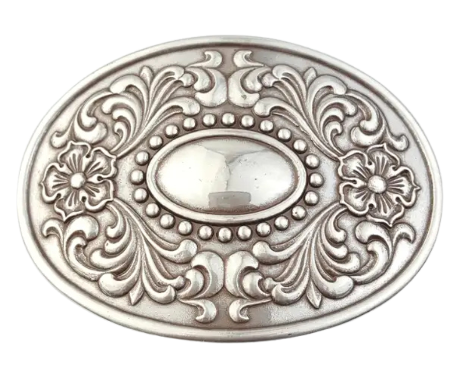 The "Victorian" buckle features an oval design adorned with western-style flowers framing a beaded oval center that resembles a rustic, unpolished mirror. It fits a standard 1 1/2" belt and measures about 2 1/2" by 3 3/4". Finished in antique silver, this charming buckle is ready to add a touch of vintage flair. Grab yours online or visit us in Smyrna, TN, just a stone’s throw from Nashville!