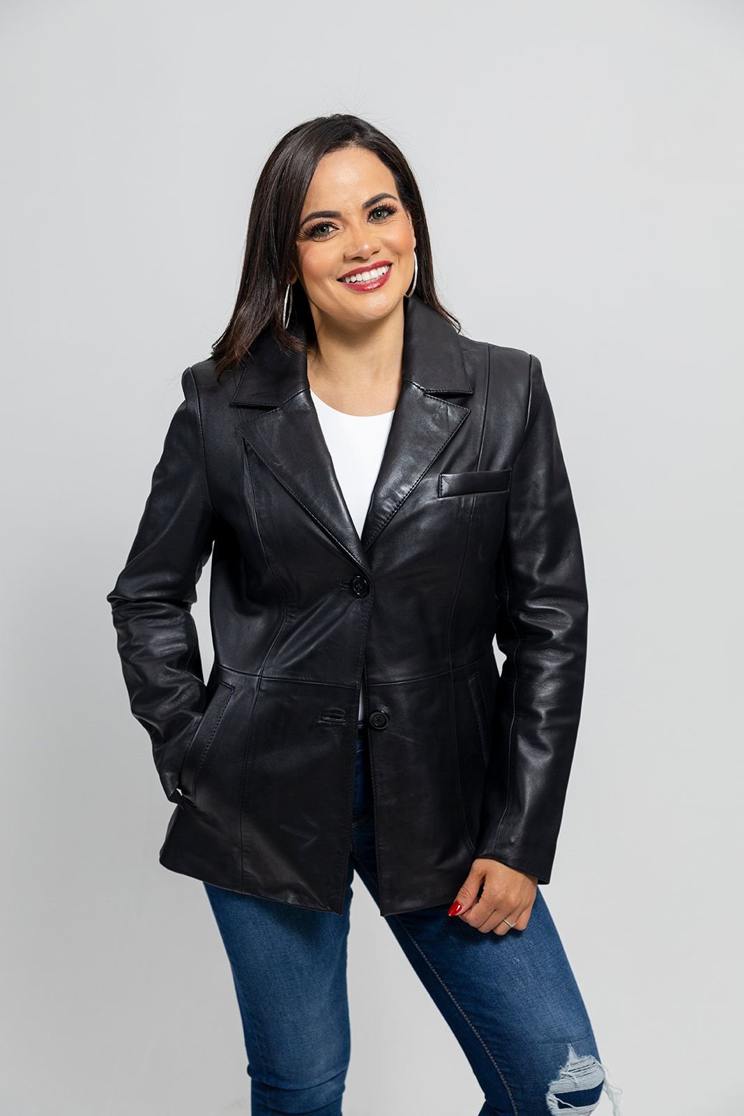 The Dahlia is a classic mid length two button blazer that gives any outfit a sleek and polished look. Available in black. Lambskin leather. Classic fit. Fully lined. One chest pocket. Two hand pockets. Button detail on sleeves. You can find it near Nashville, in Smyrna, TN.

Sizes XS-5XL Call for size availability.