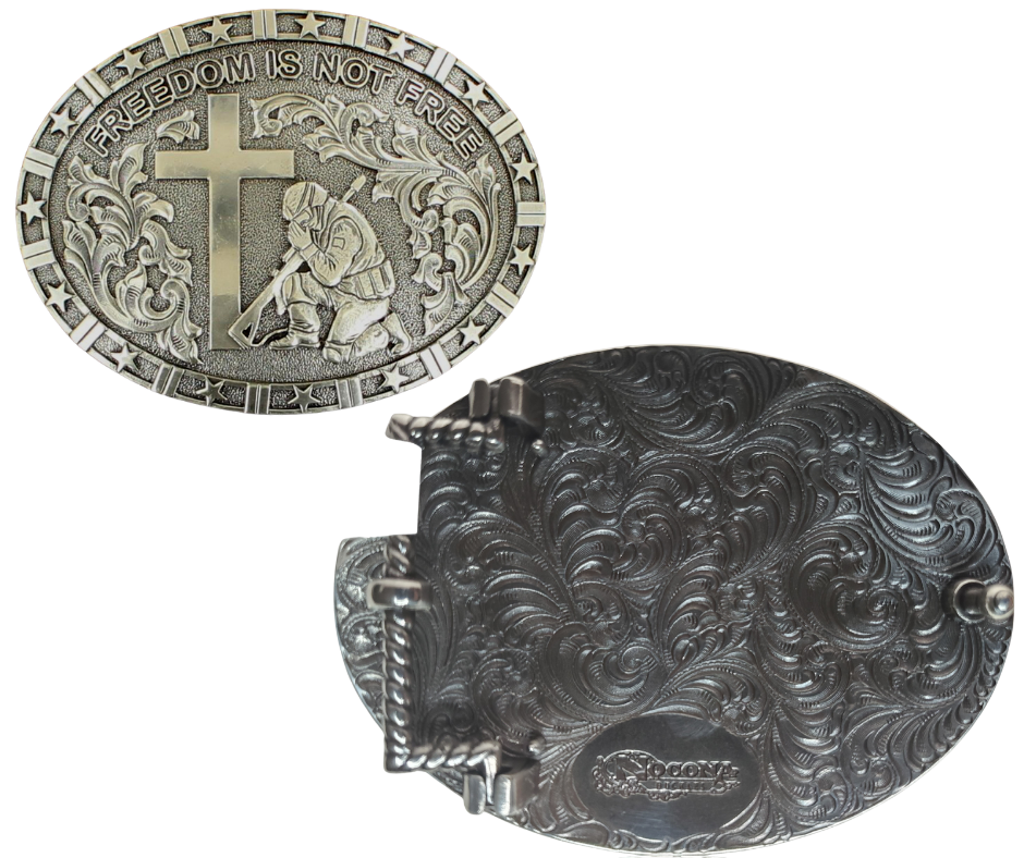 This oval-shaped buckle from Nocona showcases that our nation's veterans will never be forgotten. With its patriotic stars around the edge and Western scrollwork, plus the depiction of a Soldier kneeling at a Cross, it serves as a beautiful reminder. Roughly 2 3/4" tall and 3 3/4" wide, it's designed to fit belts up to 1 1/2" wide. Pick up your own at our retail store in Smyrna, TN (just outside Nashville) or shop online! Imported.
