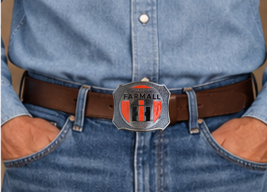 Farmall International Harvester Belt Buckle, Shield shaped with classic logo in Red, Black on antique Silver background. Size approx. 3 3/4" wide x 2 3/4" height, Fits up to 1 1/2" wide belts. Available in our shop in Smyrna, TN just outside Nashville as well as from this online store.