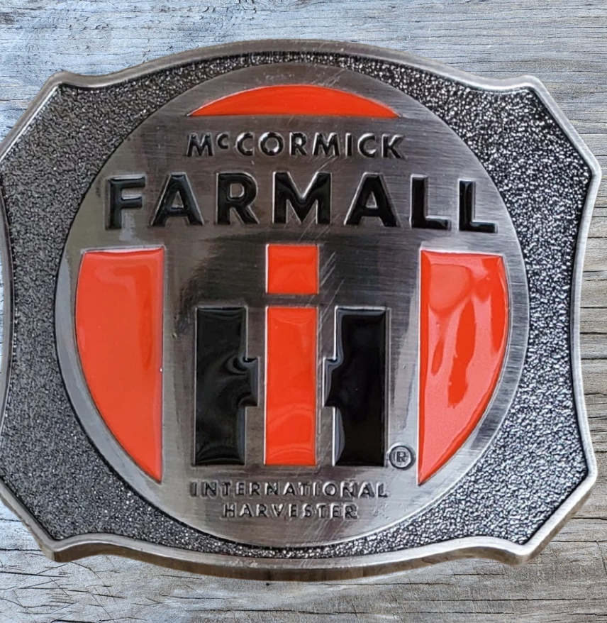 Farmall International Harvester Belt Buckle, Shield shaped with classic logo in Red, Black on antique Silver background. Size approx. 3 3/4" wide x 2 3/4" height, Fits up to 1 1/2" wide belts. Available in our shop in Smyrna, TN just outside Nashville as well as from this online store.
