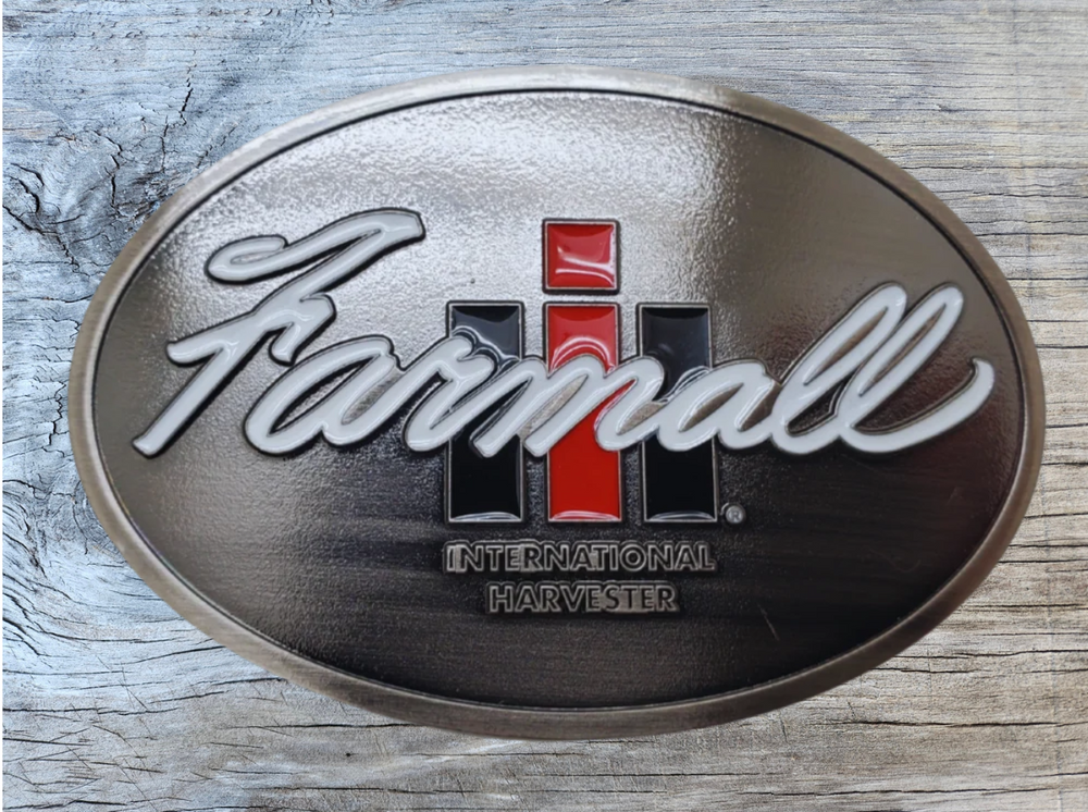 Fully Licensed Farmall International Harvester Belt Buckle, oval shaped with classic logo in Red, Black and White. Size approx. 3 3/4" wide x 2 3/4" height, Fits up to 1 1/2" wide belts. Available in our shop in Smyrna, TN just outside Nashville as well as from this online store.
