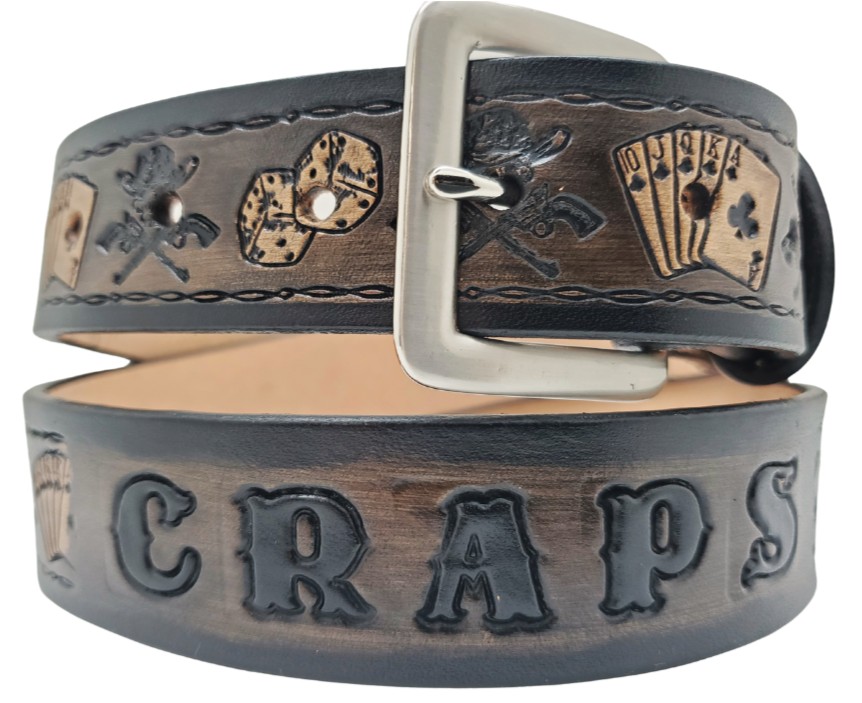 "The Gambler" is a handmade real leather belt made from a single strip of cowhide shoulder leather that is 8-10 oz. or approx. 1/8" thick. It has hand burnished (smoothed) edges and Aces, Eights, Dice, Clubs, Diamonds, Spade pattern down the center. This belt is completely HAND dyed with a multi step finishing technic. The antique nickel plated solid brass buckle is snapped in place with heavy snaps. This belt is made just outside Nashville in Smyrna, TN.