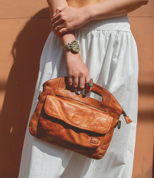 The Greenway Handbag, streamlined carry with security built in. Crafted from Artisan full-grain, vegetable-tanned leather. Reinforced dual top handles and a removable crossbody strap. Outside has a zip pocket and a magnet closure pouch. Secure zip-top closure. Inside organic cotton lining with two slip pockets, one zip pocket, and a key leash.  Made by Bed/Stu and now stocked at our Smyrna, TN store.

Measurements: 12" L x 10.25" H
Handmade and hand-finished in León, Mexico