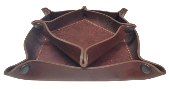 Make it PERSONAL! This handmade real leather valet tray can be personalized with up to 8-10 letters. It has Antique Brass SNAPPED corners to FLATTEN out for easy packing for travel. It is made in our Smyrna, TN shop just outside Nashville. It is a perfect catch-all for keeping keys and other small items in one place at the end of a long day. Makes a great gift for groomsmen, or that special someone.

Med. Approx. 7"x 7" (snapped)
Small Approx. 4.5"x 4.5" (snapped)