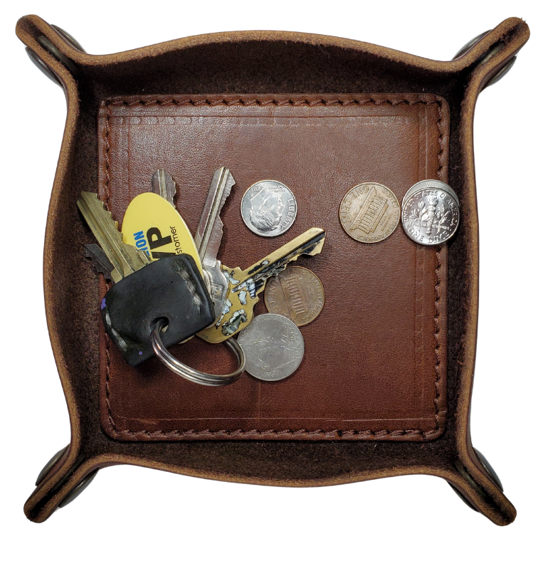 Make it PERSONAL! This handmade real leather valet tray can be personalized with up to 8-10 letters. It has Antique Brass SNAPPED corners to FLATTEN out for easy packing for travel. It is made in our Smyrna, TN shop just outside Nashville. It is a perfect catch-all for keeping keys and other small items in one place at the end of a long day. Makes a great gift for groomsmen, or that special someone.

Med. Approx. 7"x 7" (snapped)
Small Approx. 4.5"x 4.5" (snapped)