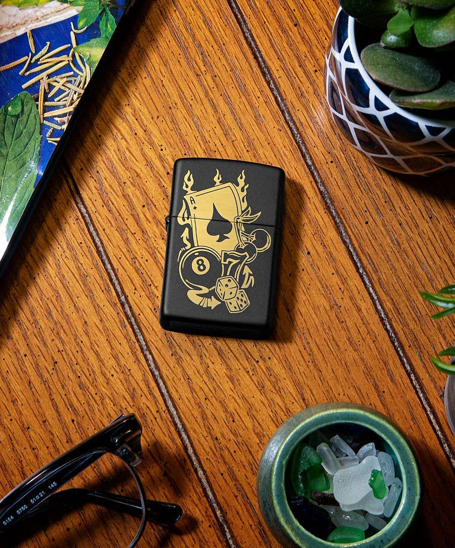 This Gambling Design is laser engraved on a Black Matte lighter displaying casino inspired elements. All metal construction; windproof design works virtually anywhere. Refillable for a lifetime of use. Comes packaged in a gift box. Available in our Smyrna, TN shop.

Made in USA
Fuel: Zippo lighter fuel (sold separately)
Lighter Specs: Height: 2.25" Width: 0.5" Depth: 1.5" Weight: 2.0 oz
Lifetime guarantee that "it works or we fix it free™" Zippo contact info on gift box.