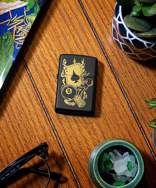 This Gambling Design is laser engraved on a Black Matte lighter displaying casino inspired elements. All metal construction; windproof design works virtually anywhere. Refillable for a lifetime of use. Comes packaged in a gift box. Available in our Smyrna, TN shop.

Made in USA
Fuel: Zippo lighter fuel (sold separately)
Lighter Specs: Height: 2.25" Width: 0.5" Depth: 1.5" Weight: 2.0 oz
Lifetime guarantee that "it works or we fix it free™" Zippo contact info on gift box.