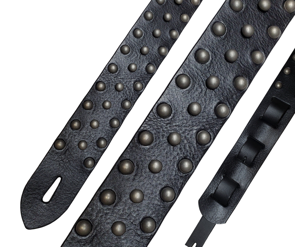 Metal Studs have been staple for years in Rock music!  "This 2" wide Guitar Strap is a nod to that classic influence. It's made from 1/8" thick Classic Black Pebble Grain Cowhide and after some gig's it'll look like you bought in a Vintage shop. The classic adjustment style goes from approx. 42" to 56" at it's longest . Made just outside Nashville in our Smyrna, TN. shop. It will need a bit of time to "break in" but will get a great patina over time.  