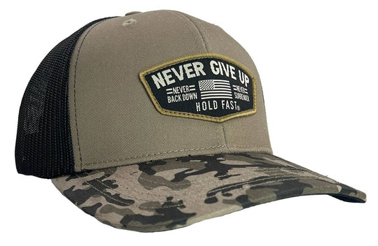 Hold Fast and Stand your ground in this rugged “Never Give Up” Cap by Kerusso. Be prepared to stand up for who and what you believe in.&nbsp; Love of God, love of family, and love for your country. We sell these at our Smyrna, TN shop because we BELIEVE too!

Color: Black/Gray Camo * 100% Polyester
Mid-Rise structured * Polyester front with woven label scout patch&nbsp;
Mesh back with snap closure * Do not launder
One size fits most