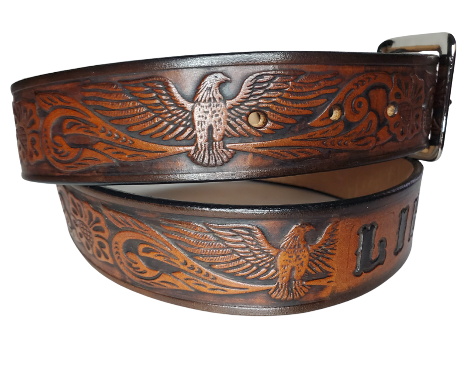 This Name Belt features a single strip of vegetable tanned leather in a patriotic pattern, highlighted by a flying eagle. The antique nickel-finished solid brass buckle is easily replaceable, allowing you to customize the design with your own buckle. It's crafted in our Smyrna, Tennessee shop, near Nashville.
