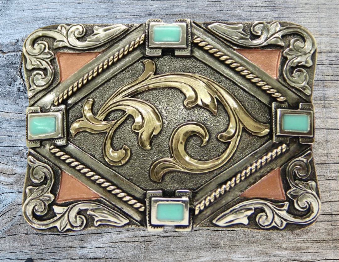 The Hebilla Western inspired buckle combines Stones and Scrolled designs buckle has a rectangle shape. This buckle is made from German Silver (nickel and brass alloy) or iron metal base. Some buckles have motifs made of copper, iron or brass and some are adorned with synthetic stones. Buckle size is Width 3.5” Height 2.5” and is available in our Smyrna, TN shop.  Buckle Width 3.5” Height 2.5” Fit&