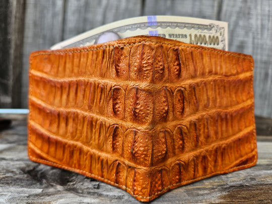 If you appreciate craftmanship this USA Made Genuine Hornback Crocodile Bifold will do the trick. Genuine Ostrich Lining is complete with matching Leather Lining, 1 Bill Pocket, 8 Card Slots, 2 Inner Side Pockets. Each hide is unique, each wallet is unique! Handmade in USA and sold in our Smyrna, TN shop not far from the gulch downtown Nashville.

Thin profile