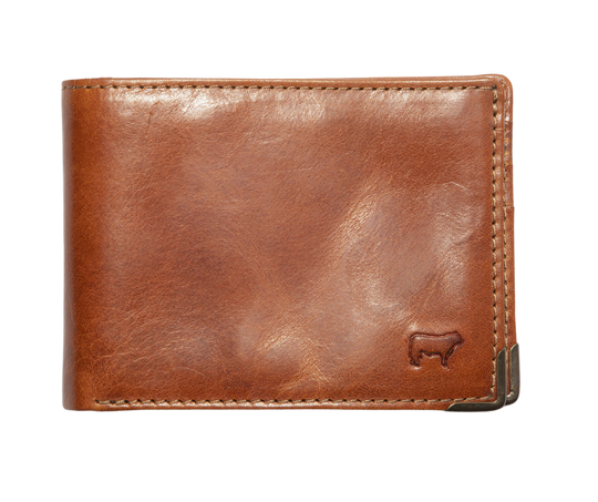 A traditional billfold with an internal antique brass money clip to secure cash. Includes three card slots and a mesh ID slot with an additional pocket underneath. Bottom right corners are reinforced by antique brass. Compact 4.25” x 1” x 3.5” made Certified Full Grain Italian Veg-Tan Leather, arguably the best in the world. Find yours at our Smyrna, TN close to Franklin. Made by Will Leather.