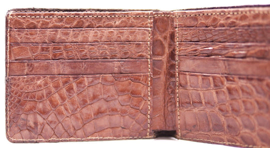 If you appreciate Hi-end craftmanship this USA Made Genuine Alligator in slight Matte Brown. Matching Alligator inside Lining with 1 Bill Pocket, 8 Card Slots, 2 Inner Side Pockets. Each hide and wallet is unique! Handmade in USA and sold in our Smyrna, TN shop not far from the gulch downtown Nashville.

Thin profile