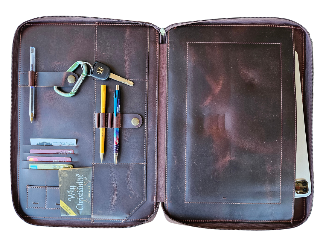 Stay organized with our Hudson Leather MacBook Portfolio. Being crafted from top-grain buffalo leather that develops character over time. Designed to fit a 13” MacBook or tablet, this portfolio features a dedicated laptop sleeve, phone sleeve, power bank slot, and five pen holders, ensuring all your essentials are neatly stored. Whether for work or on the go, this portfolio is a timeless blend of elegance and efficiency. Part of our Home and Office leathers at our Smyrna, TN shop.