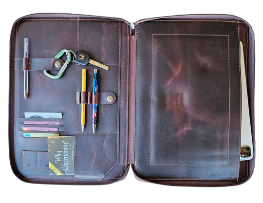 Stay organized with our Hudson Leather MacBook Portfolio. Being crafted from top-grain buffalo leather that develops character over time. Designed to fit a 13” MacBook or tablet, this portfolio features a dedicated laptop sleeve, phone sleeve, power bank slot, and five pen holders, ensuring all your essentials are neatly stored. Whether for work or on the go, this portfolio is a timeless blend of elegance and efficiency. Part of our Home and Office leathers at our Smyrna, TN shop.
