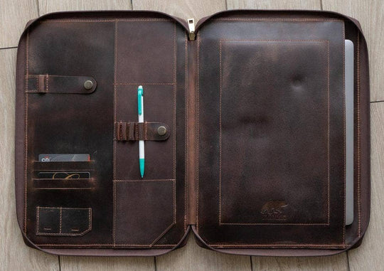 Stay organized with our Hudson Leather MacBook Portfolio. Being crafted from top-grain buffalo leather that develops character over time. Designed to fit a 13” MacBook or tablet, this portfolio features a dedicated laptop sleeve, phone sleeve, power bank slot, and five pen holders, ensuring all your essentials are neatly stored. Whether for work or on the go, this portfolio is a timeless blend of elegance and efficiency. Part of our Home and Office leathers at our Smyrna, TN shop.