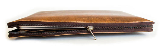 Stay organized with our Hudson Leather MacBook Portfolio. Being crafted from top-grain buffalo leather that develops character over time. Designed to fit a 13” MacBook or tablet, this portfolio features a dedicated laptop sleeve, phone sleeve, power bank slot, and five pen holders, ensuring all your essentials are neatly stored. Whether for work or on the go, this portfolio is a timeless blend of elegance and efficiency. Part of our Home and Office leathers at our Smyrna, TN shop.