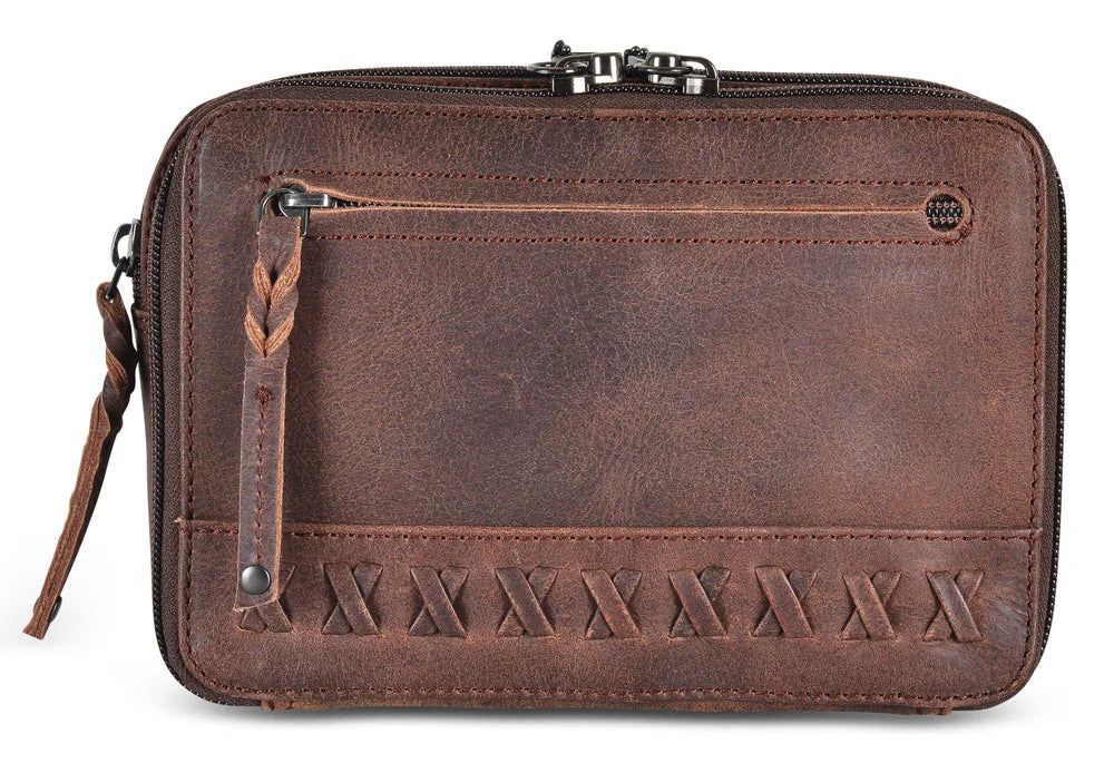The Kailey Fanny/Sling Conceal Purse is crafted with genuine buffalo leather. This is just not your average fanny pack. The bag is highlighted with beautiful crisscross lacing or decorative studs. Unzip the front flap for easy access to your weapon. Additional storage is provided by a slip pocket on the back and a decorative zippered pocket on the front. Can be worn around the waist or as a sling. Part of our leather conceal handbags at our Smyrna, TN shop.