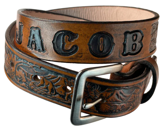 Perfect for the Outdoors type the Wilderness scene embossed on veg tanned cowhide belt, about 1/8" thick, 1 1/4" width, burnished painted edges. The buckle easily snaps into place, allowing for easy changing when desired. Handcrafted with care in our Smyrna, TN shop, our Lil&