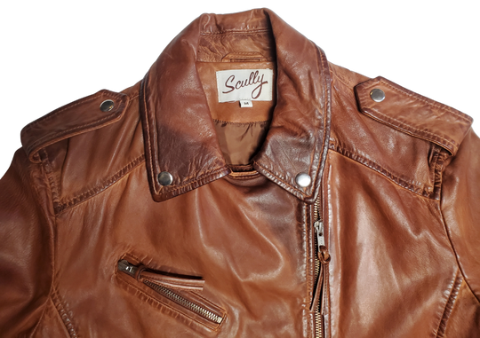 A Timeless Classic leather Modern moto Jacket in Vintage brown by Scully. Expertly tailored from Super soft, high quality leather. The sleek silhouette is slightly fitted at the waist to flatter. Your shape, while shoulder epaulettes and polished hardware add a classic motto finish. Get yours at our Smyrna, TN shop not far from crazy downtown Nashville.

Effortless attitude to any outfit.
Asymmetrical front zip closure, notch lapels with. Snap buttons
Multiple zippered and flap pockets