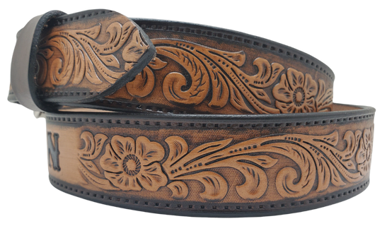 Unleash your western inner self with The "Lariat" Name Belt. Each belt features a unique hand-stained strip of vegetable tanned leather, adorned with a bold and timeless Western Floral pattern. The antique nickel finish solid brass buckle can be effortlessly swapped out. Crafted by hand at our Smyrna, Tennessee shop, just a stone's throw away from Nashville.
