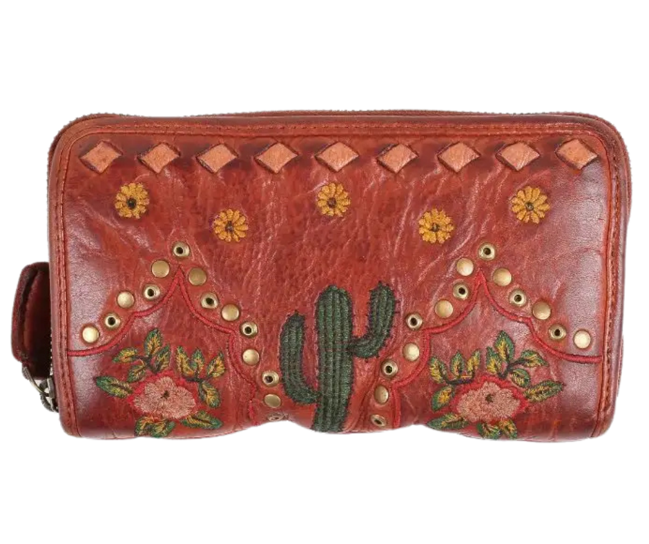 If a Desert was a wallet it would a Saguaro cactus design, embroidered sunflowers, desert roses, and distressed metallic embellishments for that Western flair, all crafted from the signature butter-soft calf Nappa leather. And don't miss the touch of distressed white lace - because who says a wallet can't have a little fun? Ride over and snag yours at our Smyrna, TN shop, not far from the wild west of downtown Nashville.
