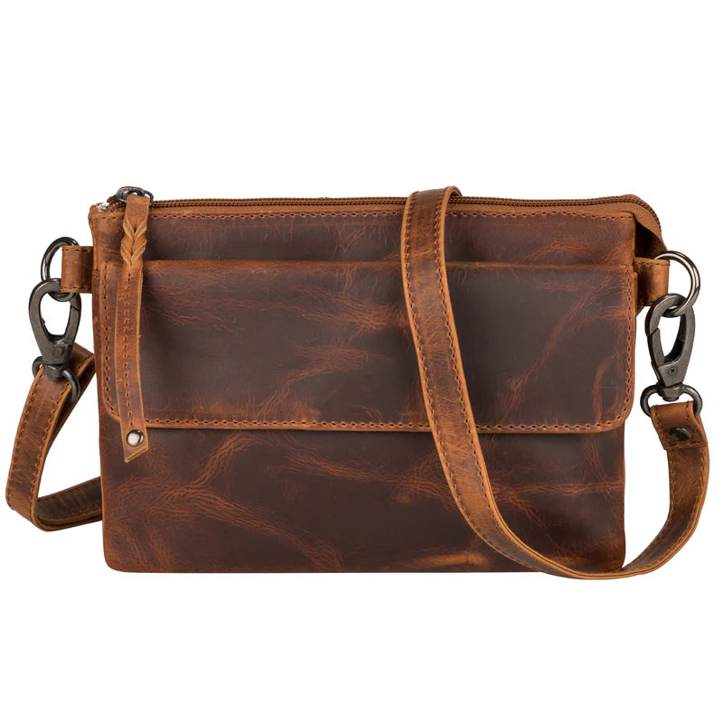 The Natasha Crossbody purse is available at our Smyrna, TN shop. Features full-grain leather front flap pocket, RFID-protected, includes an organizer with 4 credit card slots and a magnetic snap closure. Behind it is an open pocket with a magnetic snap closure, ideal for your cell phone. The main interior is divided into 2 parts and features a zippered pocket, an open slip pocket, and a leather key strap. The bag comes with two crossbody straps: one leather strap and a nylon camouflage strap.