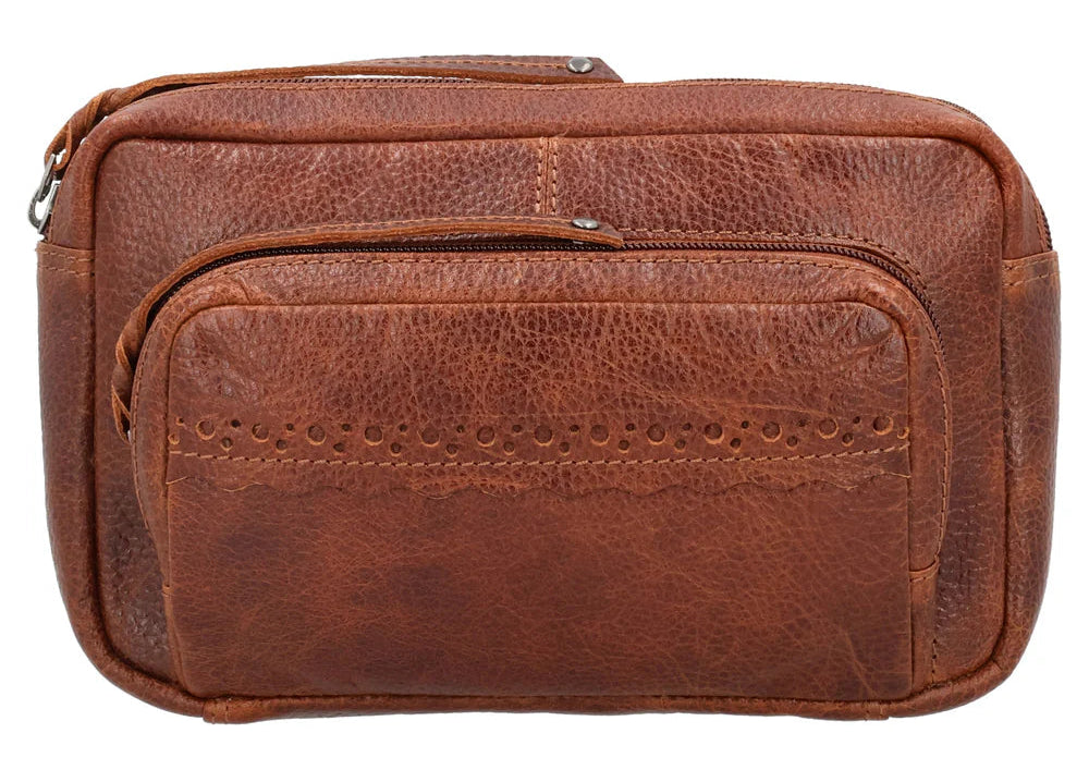 The Laney Belt Bag, crafted from buffalo leather, showcases a decorative scalloped design. This versatile accessory can be worn around the waist or as a sling, combining style and convenience. The bag is thoughtfully divided into three sections with a main interior, located in the middle compartment, secured with a leather strap with a magnetic snap closure. The concealed carry compartment is discreetly located in the back. Part of our Carry Conceal Handbags at our Smyrna, TN shop.