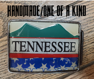 Hand Crafted Tennessee mountains look with our handmade license plate belt buckle. It's a great choice for cheering on your favorite Tennessee teams or for celebrating the great volunteer state! This eye-catching piece measures approx. 3" x 4" and can be matched with any 1 1/2" belt. Get yours today from our Smyrna, TN (near Nashville) store or online and show your style!