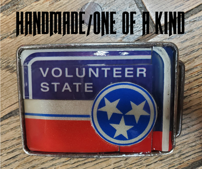 Hand Crafted Tennessee Volunteer look with our handmade license plate belt buckle. It's a great choice for cheering on your favorite Tennessee teams or for celebrating the great volunteer state! This eye-catching piece measures approx. 3" x 4" and can be matched with any 1 1/2" belt. Get yours today from our Smyrna, TN (near Nashville) store or online and show your style!