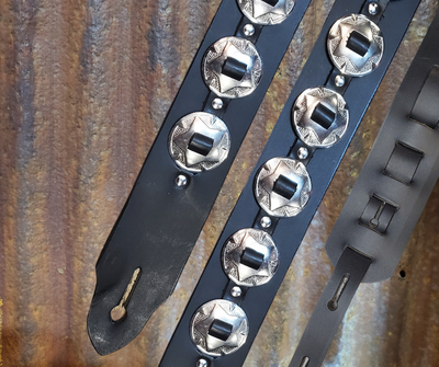 Conchos like Marshalls and Les Paul's have have been staple for years in Rock music!  "This 2" wide Guitar Strap is a nod to that classic influence. It's made from Pebbled Veg-Tan Cowhide and after some gig's it'll look like you bought in a Vintage shop. The classic adjustment style goes from approx. 42" to 56" at it's longest . Made just outside Nashville in our Smyrna, TN. shop. It will need a bit of time to "break in" but will get a great patina over time.  