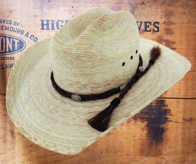 You ain't no cowboy unless you have an authentic horse hair hatband. Southwest sunburst conchos adorn the 1/2 inch wide braid of horse hair. Finished with hitched horse hair knots and tassels, this classic hatband is fully adjustable to fit any hat.You can find it at our shop in Smyrna, Tn. Each piece is crafted in Montana using horsehair mainly sourced from Argentina, Mongolia, and Canada.