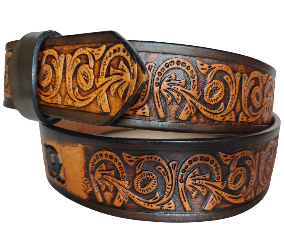 We are always trying to find classic iconic patterns and this is one of those....Horseshoes mixed with a Western scroll pattern. It's a professionally crafted, genuine leather belt made from 8-10 oz cowhide shoulder leather, approximately 1/8" thick. It boasts a hand burnished edge, along with a multi-step dye and finishing technique. The antique nickel plated solid brass buckle is affixed with heavy snaps. This belt is crafted near Nashville, TN in Smyrna.