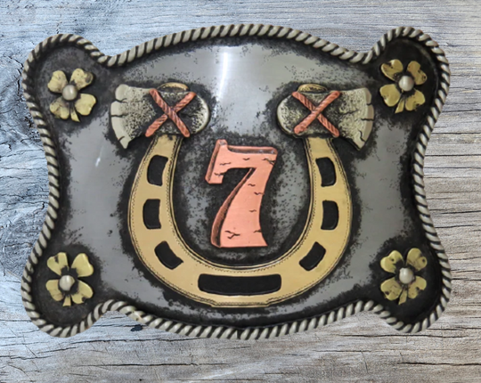 The Lucky 7 buckle is made from German Silver (nickel and brass alloy) or iron metal base. Each piece is punched, cut, soldered, engraved, polished and painted by our talented metal workers.  Our products are all handcrafted. Finally each piece is covered with a heat sealed lacquer to ensure the piece&