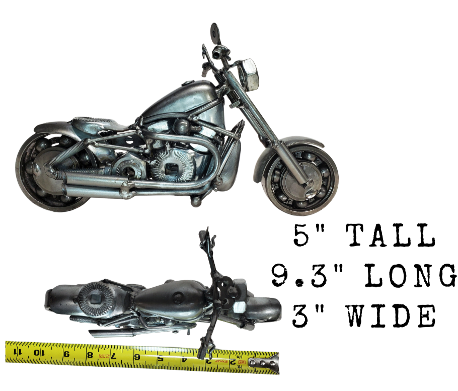 Enhance your Man Cave with this one-of-a-kind motorcycle metal art! A great gift for any motorcycle lover, this piece was crafted with nuts, bolts, washers, springs, and bearing wheels for a unique touch. It even stands on its own, thanks to the kickstand. For specific measurements, please refer to the photo. Motorcycle METAL artwork is currently available at our Smyrna store, just minutes from Nashville, TN.