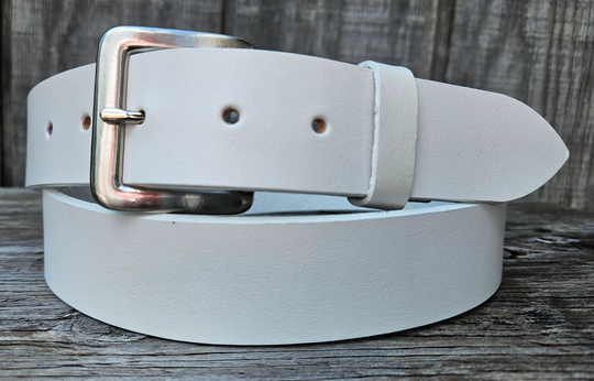 This solid strip of top grain leather has a satin finish White surface, and a width of 1 1/2". Will soften with normal wear. Sizes available are 34" to 44" from buckle end to hole most worn. The buckle is easy to change. One of a few USA made belts not produced in our Smyrna TN shop.