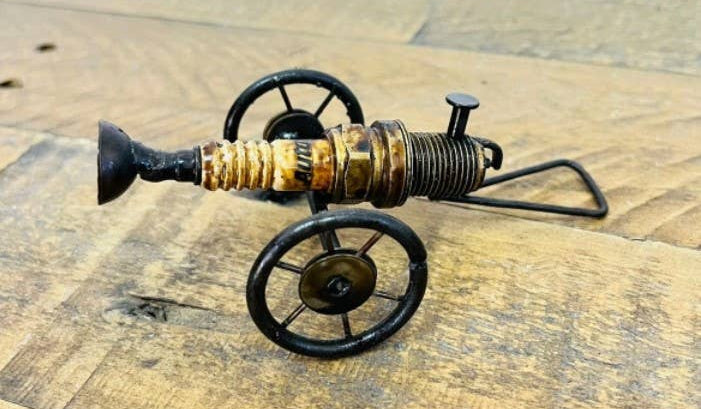 Handmade Recycled Sparkplug Art. Made with Rustic recycled metal and may have visible scratches or imperfections due to their previous use. We strive to minimize these blemishes, but they are a natural result of the recycling process. Stocked at our Smyrna, TN shop close to the Nissan plant.&nbsp;

* 3.5" H x 5.5" L x 3" W