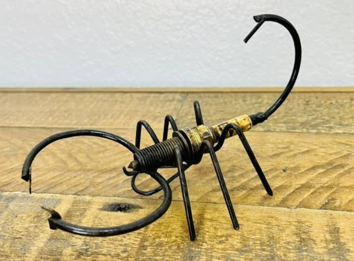 Handmade Recycled Sparkplug Art. Made with Rustic recycled metal and may have visible scratches or imperfections due to their previous use. We strive to minimize these blemishes, but they are a natural result of the recycling process. Stocked at our Smyrna, TN shop close to the Nissan plant.&nbsp;

* 3.5" H x 5.5" L x 3" W