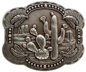 Take a trip to the desert with our "Strawflower Feathers" Belt Buckle! Featuring a design of cacti, mesas, and feathers, this antique silver-colored piece measures 3" tall by 4" wide and can fit belts up to 1 1/2" wide. You can purchase it both in our retail shop located in Smyrna, TN near Nashville and online.
