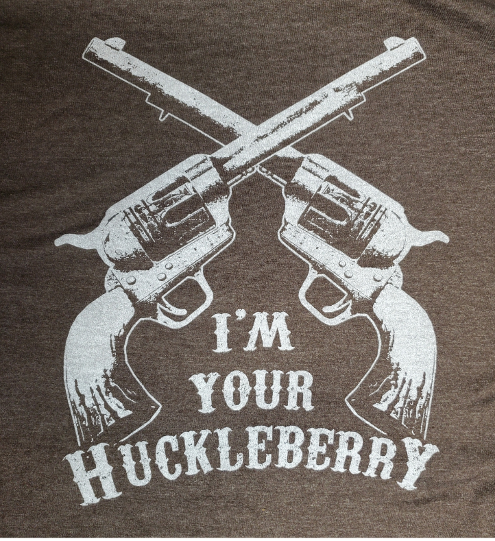 The I'm your Huckleberry line has become one of the most known in Westerns at this point. Get your's in Chocolate Brown with the famous graphic. Available online and in our retail shop in Smyrna, TN. Made of super soft 50% ring spun cotton &amp; 50% poly. Pre-shrunk.
