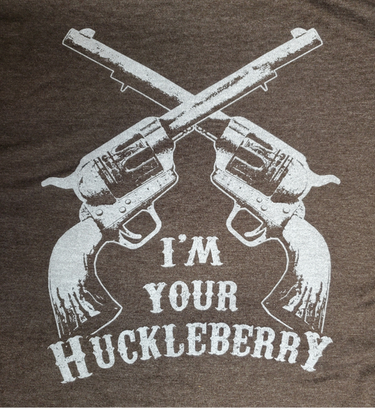 The I'm your Huckleberry line has become one of the most known in Westerns at this point. Get your's in Chocolate Brown with the famous graphic. Available online and in our retail shop in Smyrna, TN. Made of super soft 50% ring spun cotton &amp; 50% poly. Pre-shrunk.