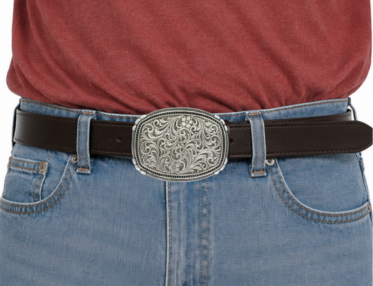 This buckle features a beautiful Intricate Classic Western Scroll pattern as the main design. Its antiqued curved rectangular shape is accented with twisted silver finished rope edging and high-domed beads, framing the bright cut Western scroll design. It can fit a standard 1.5 inch belt and measures approximately 3 3/4"" across x 3" tall. You can find it at our Smyrna, TN location, just a short drive from downtown Nashville. Made by Montana Silversmith.