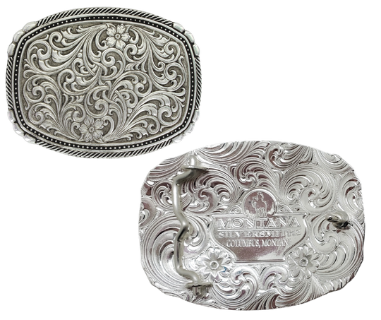 This buckle features a beautiful Intricate Classic Western Scroll pattern as the main design. Its antiqued curved rectangular shape is accented with twisted silver finished rope edging and high-domed beads, framing the bright cut Western scroll design. It can fit a standard 1.5 inch belt and measures approximately 3 3/4"" across x 3" tall. You can find it at our Smyrna, TN location, just a short drive from downtown Nashville. Made by Montana Silversmith.