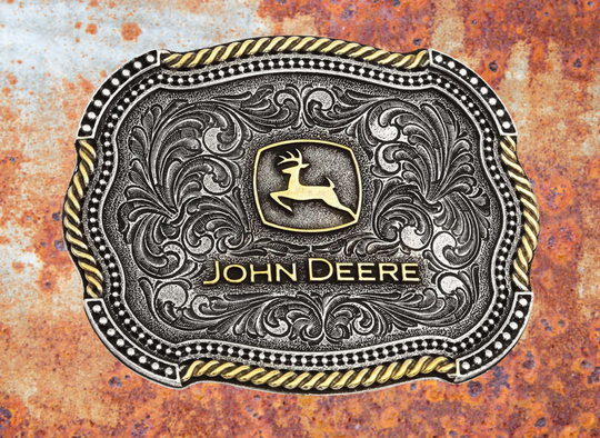 An officially licensed John Deere® two tone cast in antiqued silver and gold tones with a softly scalloped edge. The classic gold toned John Deere logo sits in the center of the buckle surrounded by antiqued silver toned filigree design. The edges of the filigree are lined by a scalloped shaped edging of silver toned microbeads with the outer edge a combination of sections gold toned rope and silver toned microbeads alternating their way around the edge. Standard 1.5 inch belt swivel. In stock at our Smyrna