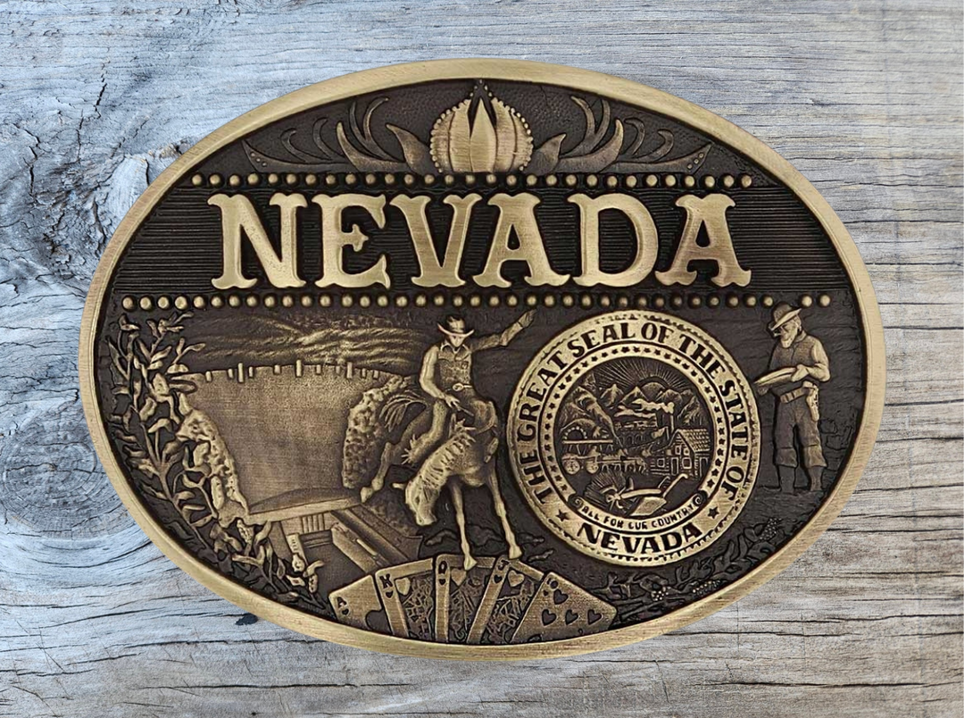 Celebrate Nevada State with this oval buckle highlighting the Hoover Dam, rodeo, hunting, gambling, and the great state seal! Brass plate over a solid cast metal alloy is antiqued and buffed to highlight the details.

Fits 1 1/2" belts and is approx. 3" tall x 4" across. Available at our shop just outside Nashville in Smyrna, TN. Made by Montana Silversmiths.