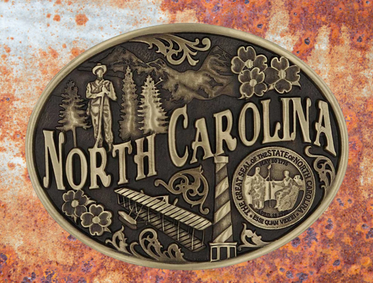 Large lettering spelling out North Carolina stretches boldly across, surrounded by a set of antiqued figures in celebration of North Carolina heritage including Cape Hatteras Lighthouse, an airplane, and the state seal. Our cast belt buckles are acid washed to add the dark antiqued patina and hand buffed to bring out the highlights and details. Standard 1.5 inch belt swivel. Get yours at our local Smyrna ,TN shop.