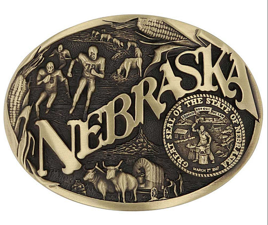Celebrate Nebraska State with this oval buckle highlighting football, corn, pioneers, and the great state seal! Brass plate over a solid cast metal alloy is antiqued and buffed to highlight the details.

Fits 1 1/2" belts and is approx. 3" tall x 4" across. Available at our shop just outside Nashville in Smyrna, TN. Made by Montana Silversmiths.